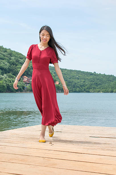 istock Woman standing in front of a lake 577953270