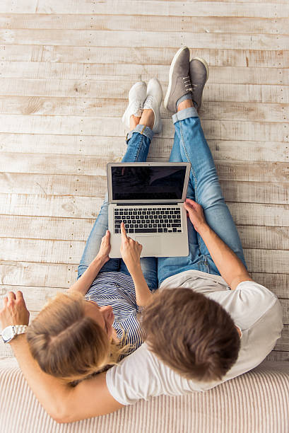 istock Beautiful young couple with gadget 577953300