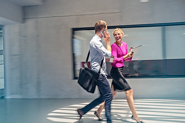istock Two businesspeople running late for a meeting 577953888