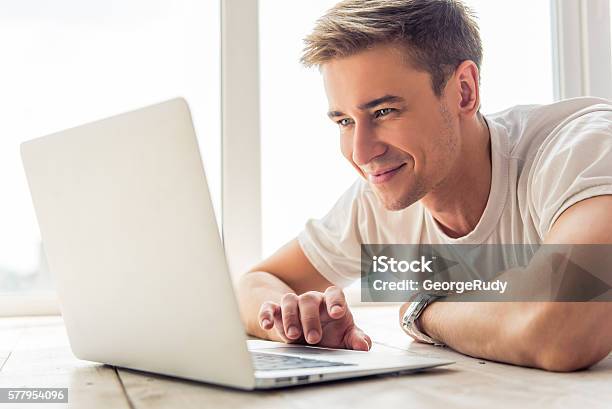 Handsome Young Man With Gadget Stock Photo - Download Image Now - Men, Laptop, Learning