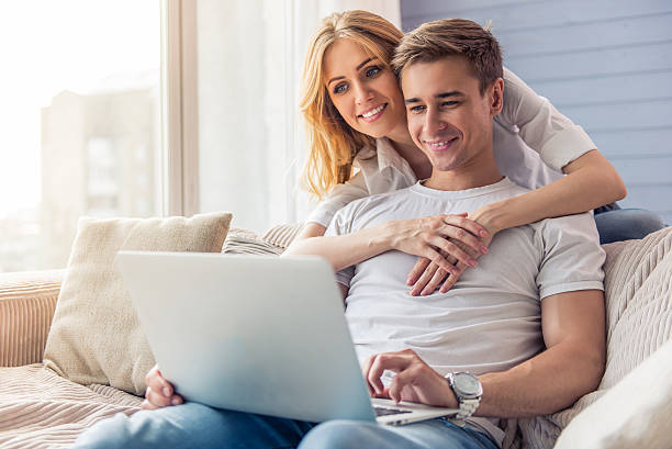 istock Beautiful young couple with gadget 577954296