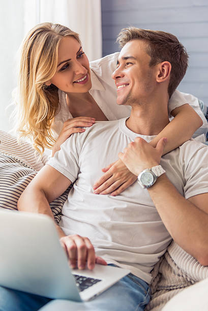 istock Beautiful young couple with gadget 577954390