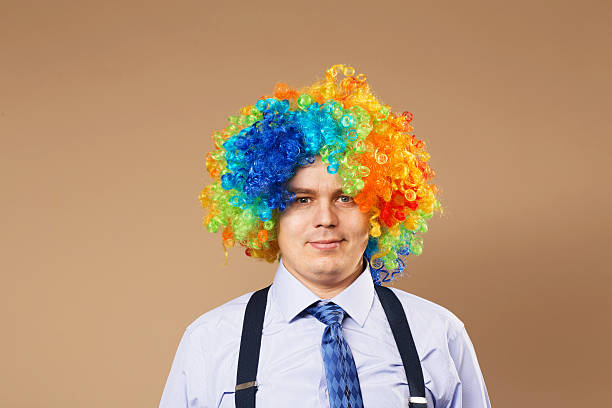 smiling businessman with large colorful wig - clown circus telephone humor imagens e fotografias de stock