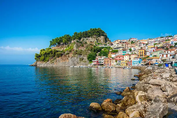 Beautiful Panoramic View of Parga Harbour, Greece. Colorful and traditional houses over reflection in the Mediterranean Sea.