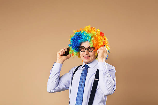 businessman respond to numerous phone calls - clown circus telephone humor imagens e fotografias de stock