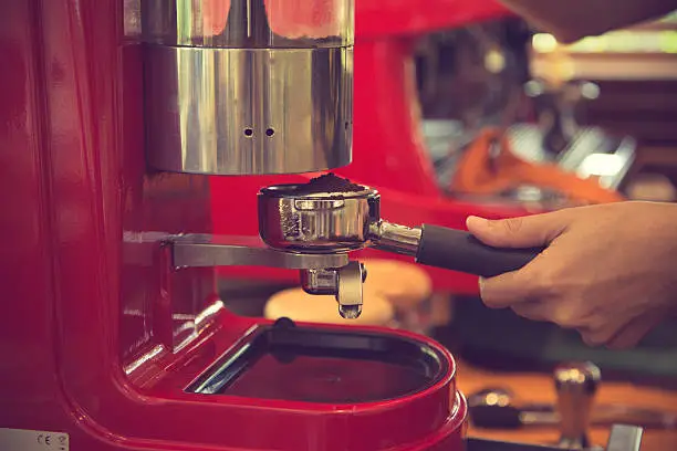 porta filter espressomachine in coffee shop background.Vintage color