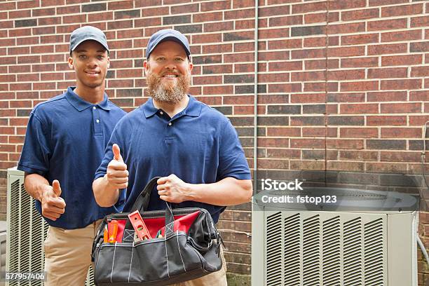 Air Conditioner Repairmen Work On Home Unit Tool Bag Stock Photo - Download Image Now