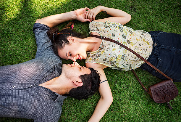 istock Sweet Couple Laying Grass Concept 577958908