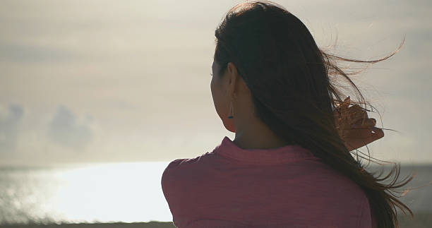 Rear view of Japanese young female on the beach.