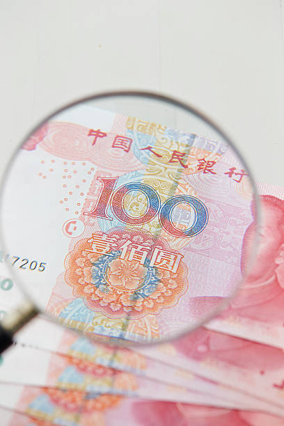 istock Magnifying glass with Chinese RMB bill 577966562