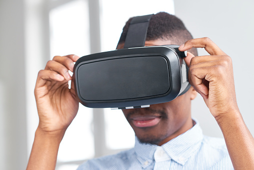 African guy adjusting virtual reality headset