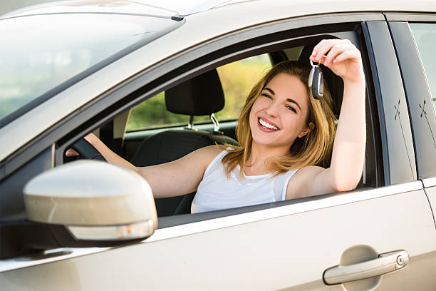 istock First car - young woman with keys 577968740
