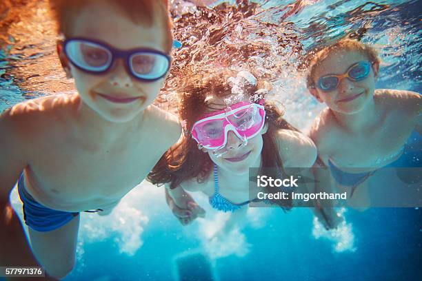 Kids Swimming Underwater Stock Photo - Download Image Now - Child, Swimming Pool, Underwater