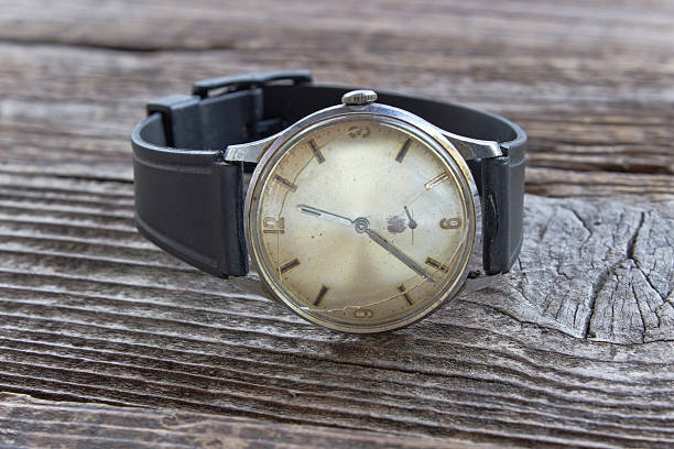 istock Old broken men wristwatch on wooden board 577971402