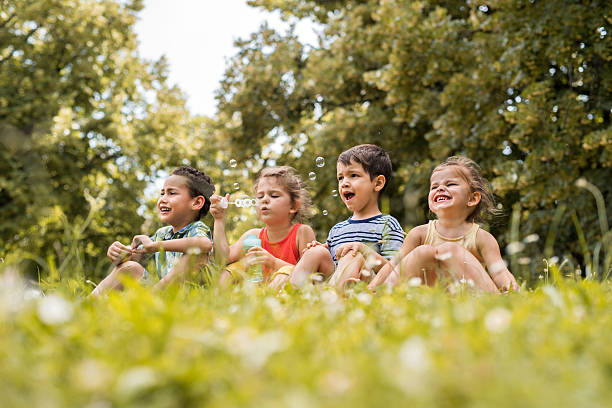 istock Group of small kids during spring day in the park. 577971702