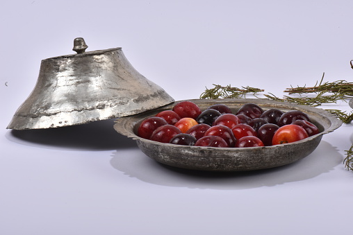 top view of a bowl with red plum