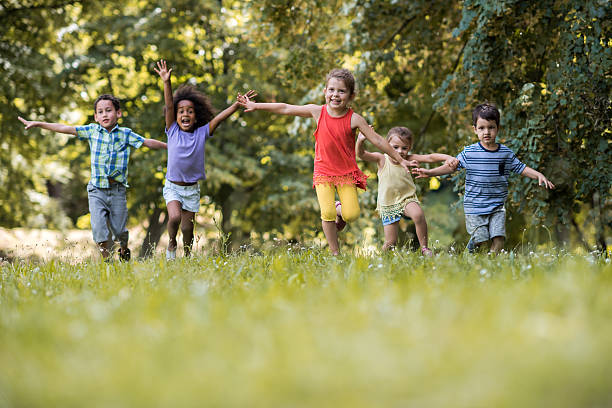 istock Group of happy children having fun while running in nature. 577972098