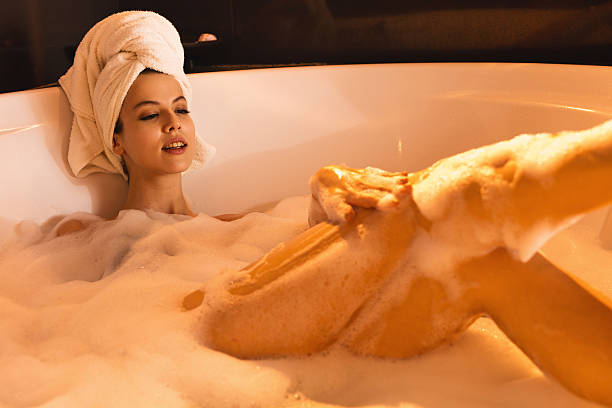 istock Young sensual woman enjoying in bubble bath. 577972654