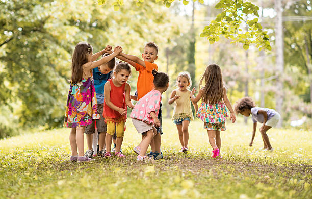 istock Group of happy children having fun in the park. 577974400