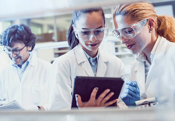 istock Two Young Female Scientists Looking at the PC tablet 577974816