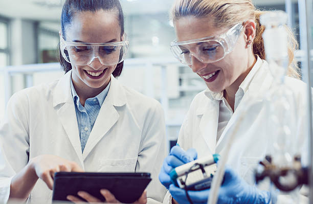 istock Two Young Female Scientists Looking at the PC tablet 577974846