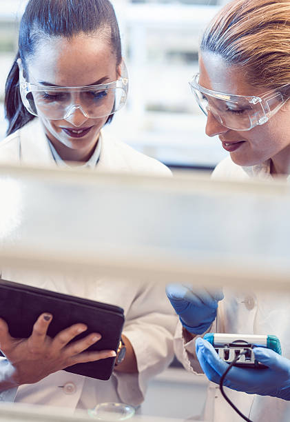 istock Two Young Female Scientists Looking at the PC tablet 577974906