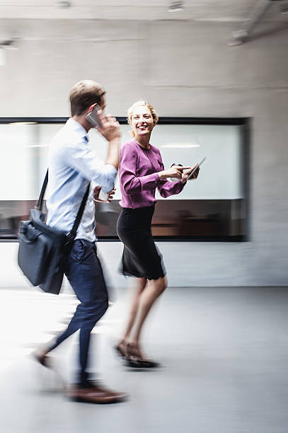 istock Business Couple Entering the Business Building 577976548