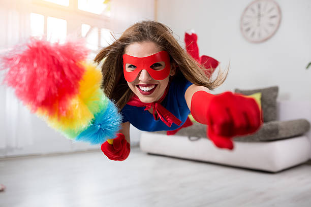 istock Smiling woman superhero flying through the room 577977342