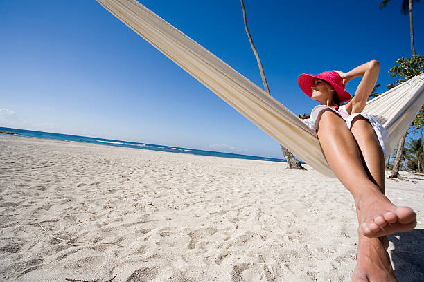 istock smiling woman in a hammock at the beach 577977444