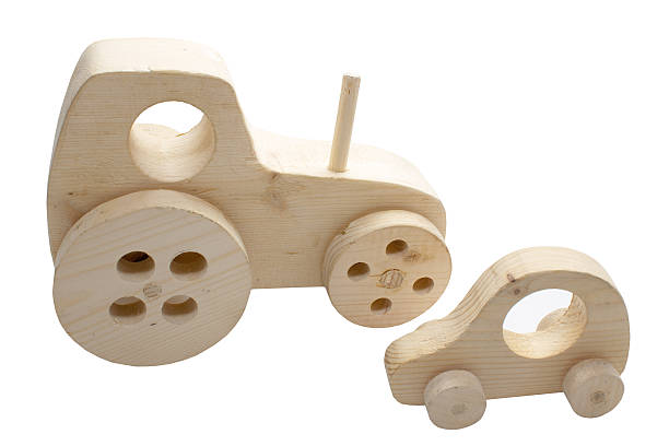 istock wooden toy tractor and a car 577977662