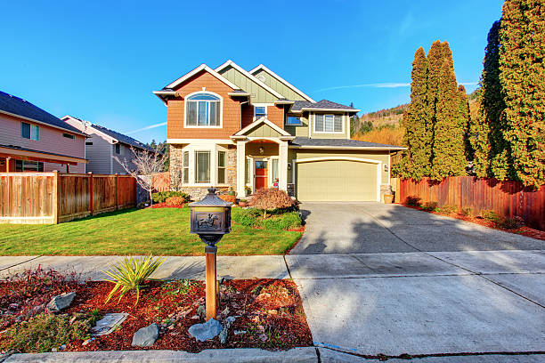 istock Classic house with garage, driveway, and grassy front yard. 577978362
