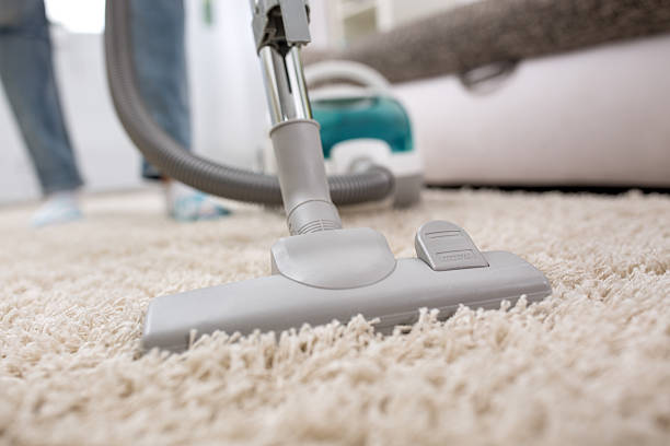 istock Woman with Vacuum Cleaner 577978736