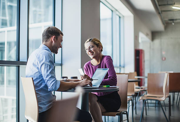 istock Business Couple Sitting at the Table and Using Portable Devices 577980412