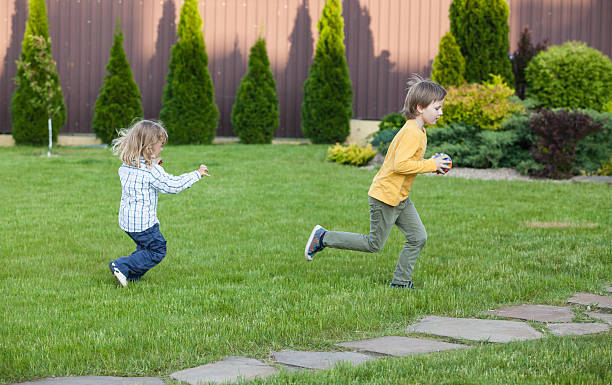 istock boys running in the garden 577980518