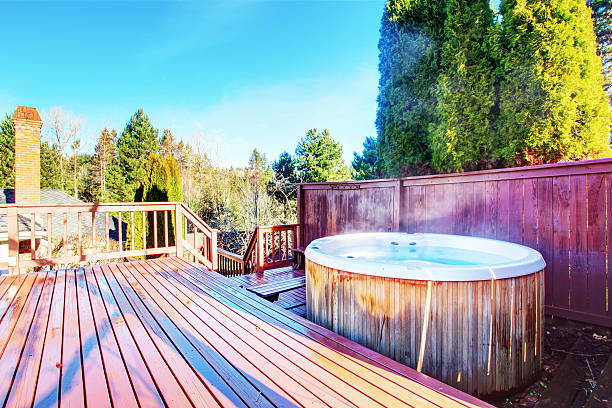 istock Fenced backyard area with hot tub and walkout deck 578075106