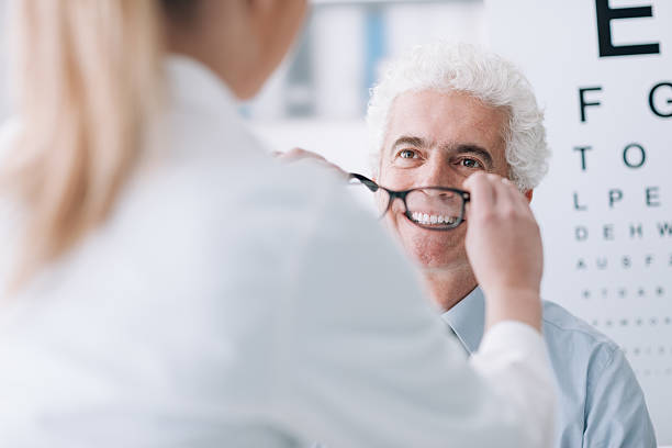 istock Optician giving new glasses to the patient 578076456