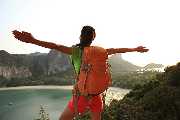 istock cheering young  woman enjoy the view on mountain peak 578076802