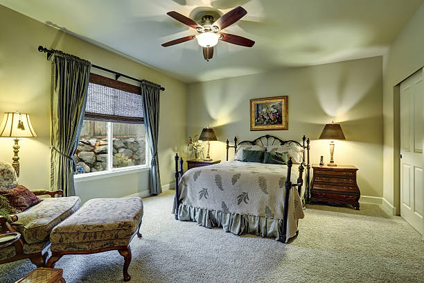 istock Small bedroom with beige walls, carpet floor 578078140