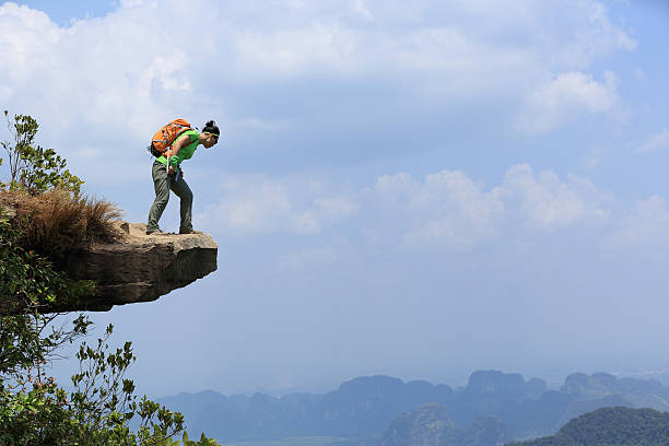 istock successful woman hiker enjoy the view at mountain peak cliff 578080210