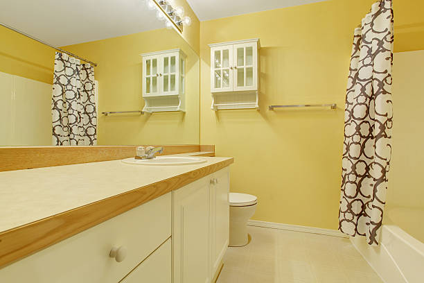 istock Yellow bathroom interior with vanity cabinet 578080866