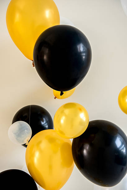 balloons yellow and black color on backdrop