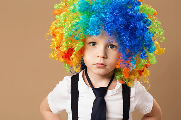 istock Happy clown boy with large colorful wig. 578081272