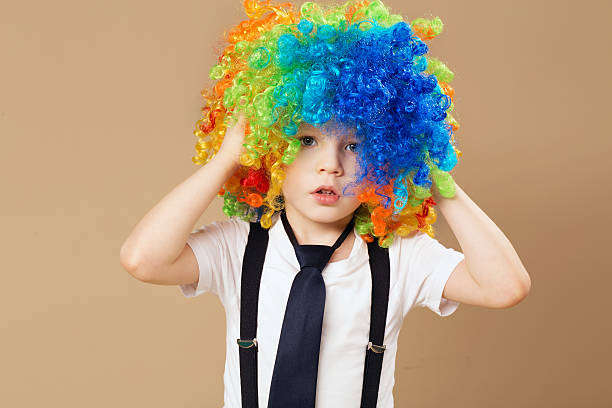 istock Little boy in clown wig smilling and having fun 578081392