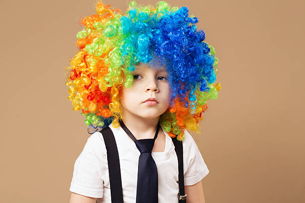 istock Sad clown boy with large colorful wig. 578081480