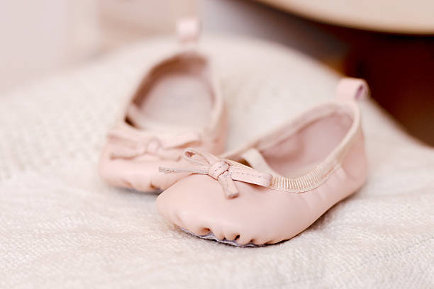 istock Pink baby booties on  background 578081770