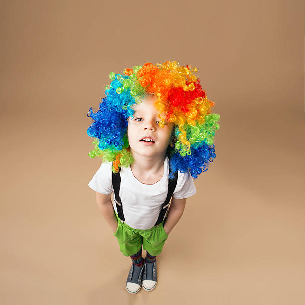 istock Happy clown boy with large colorful wig 578081806