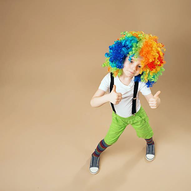 istock Happy clown boy with large colorful wig. 578081848