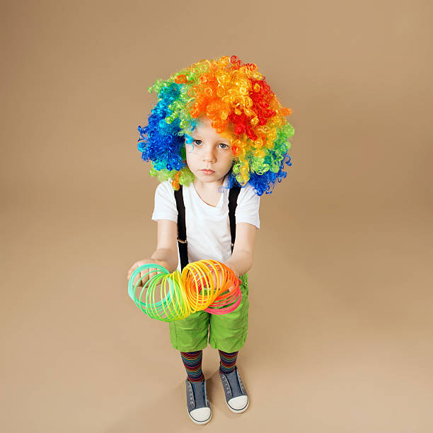 istock Happy clown boy with large colorful wig. 578081964
