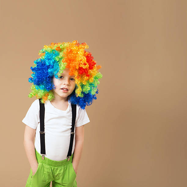 istock Happy clown boy with large colorful wig 578082180