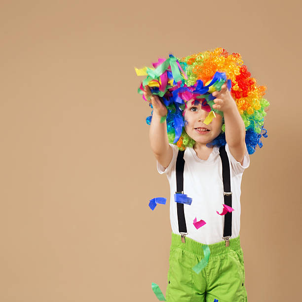 istock Happy clown boy with large colorful wig 578082238